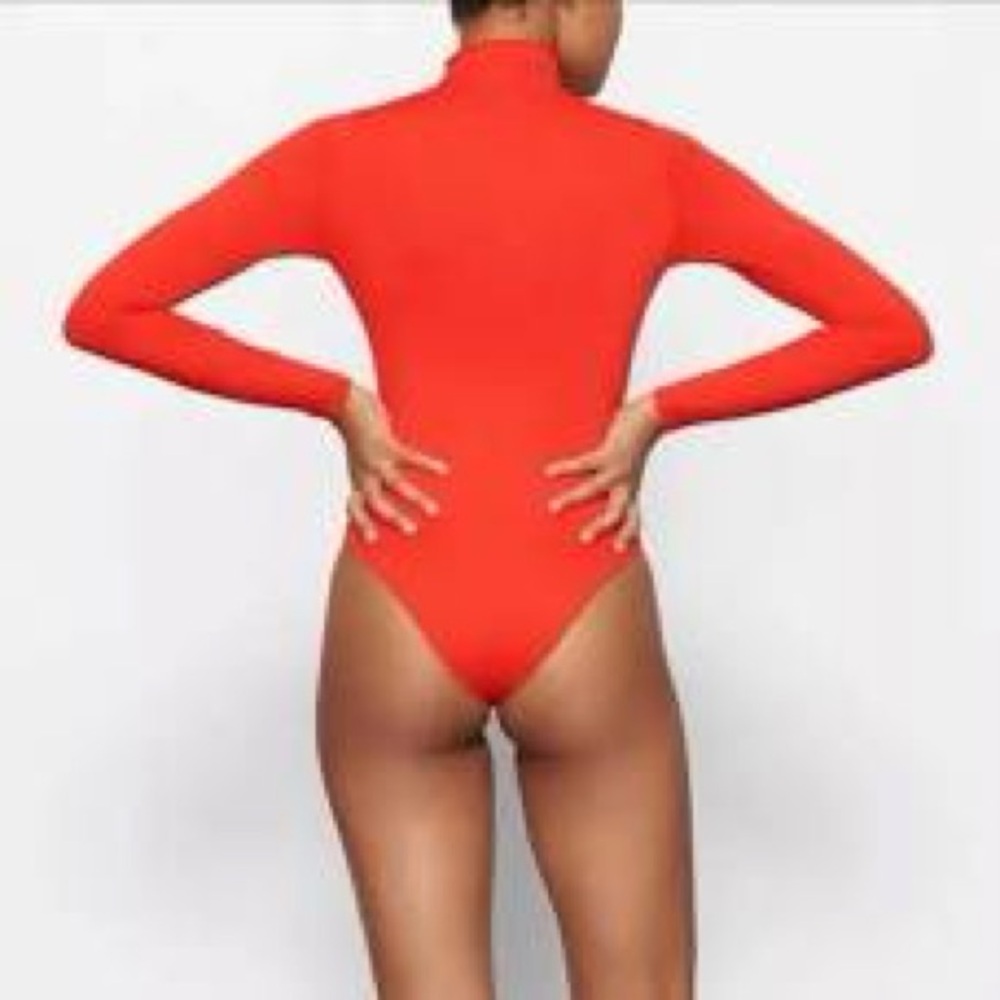 SKIMS orange mockneck long sleeve bodysuit